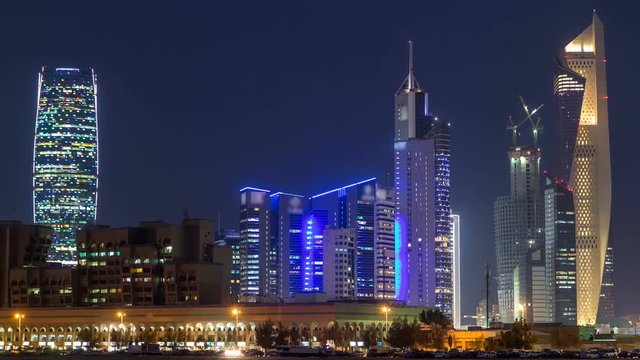 Skyline with Skyscrapers day to night timelapse in Kuwait City downtown illuminated at dusk. Kuwait City, Middle East