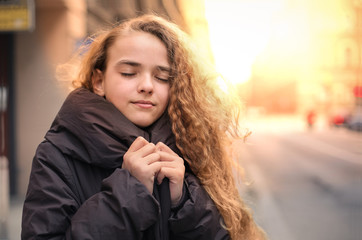 Girl wearing a warm coat in winter