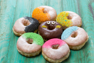 Chocolate glazed donuts and sprinkle donuts.