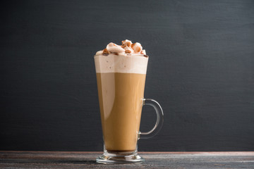 Coffee in glass on the rustic wooden background