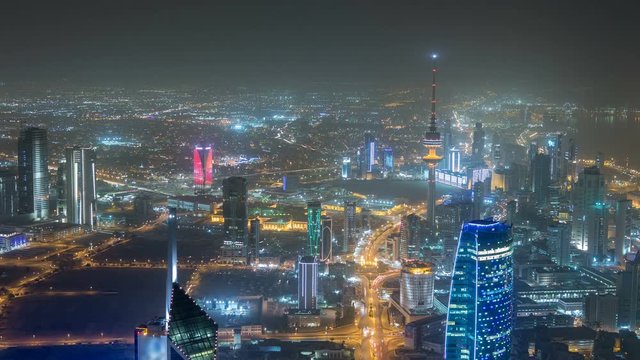 Skyline with Skyscrapers night timelapse in Kuwait City downtown illuminated at dusk. Kuwait City, Middle East