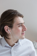 Portrait of young man listening to music with smartphone