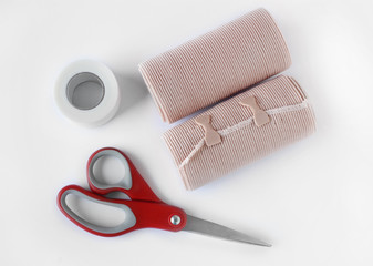 Medical bandage rolls, bandage, elastic , scotch tape, first aid supplies, a white background.
