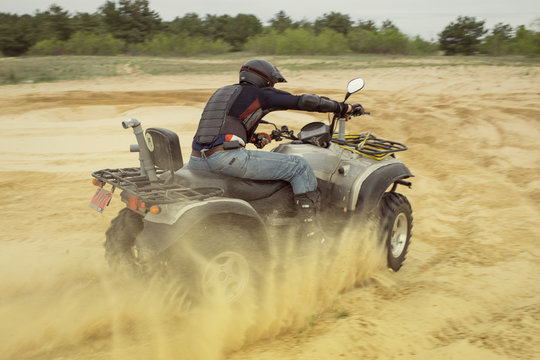 Racing ATV is sand.