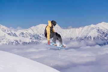 Snowboard rider jumping on mountains. Extreme snowboard freeride sport.