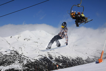 Snowboard rider jumping on mountains. Extreme snowboard freeride sport.