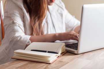 Businesswoman working on laptop in office
