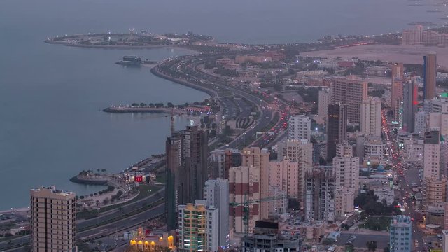 Skyline with Skyscrapers day to night timelapse in Kuwait City downtown illuminated at dusk. Kuwait City, Middle East