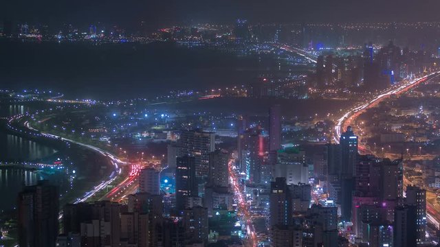 Skyline with Skyscrapers night timelapse in Kuwait City downtown illuminated at dusk. Kuwait City, Middle East