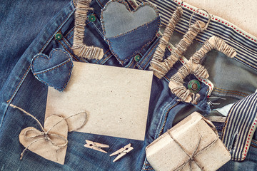 Empty brown card on background of denim trousers with cardboard