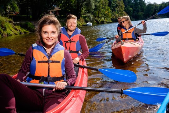 Happy best friends having fun on a kayaks