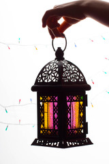 Young Muslim kid hand holding Ramadan lantern