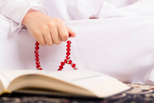 Ramadan Portrait - Hand of muslim kid making zikr