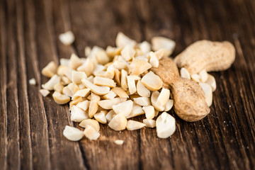 Peanuts (chopped; close-up shot; selective focus)