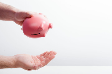 Shaking out empty piggy bank