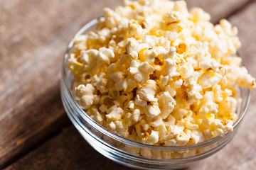 Salt popcorn on the wooden table