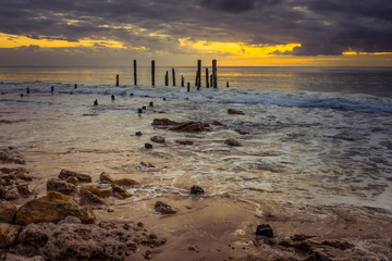 Moody sunset at Port Willunga old ruined woodem jetty poles