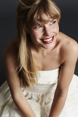 Blue eyed blond in wedding dress, smiling