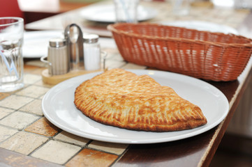 Italian pie calzone on a plate