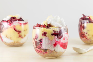 Homemade granola parfait with cherries and cream