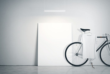Photo Interior Modern Studio Loft with Concrete Wall and Classic bicycle.Empty White Canvas on Floor, Spotlight top. Blank Tshirt hanging Bike. Horizontal mockup.