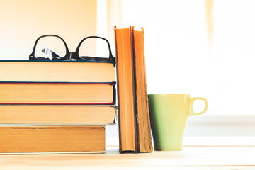 reading glasses with books on the table
