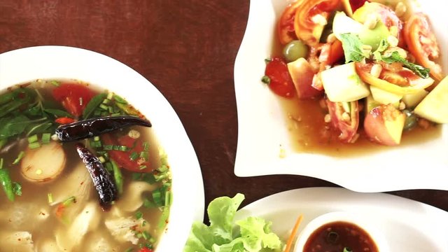 Thai fruits spicy and sour salad, grilled chicken and fish sauce wings