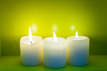 Fototapeta na wymiar Colorful scented candles on a dark green background