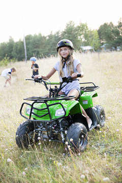 Girl riding four-wheeler, Sweden