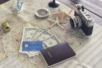 Fototapeta premium ship figurine, compass, passport, credit card, banknote, camera