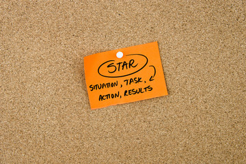 Business Acronym STAR written on orange paper note