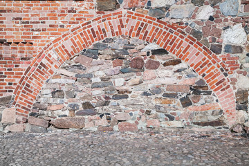 Old stone wall and asphalt floor