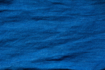 Closed up of blue creased denim jeans texture