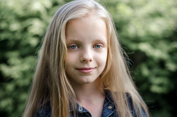 Portrait of a beautiful blonde little girl with long hair