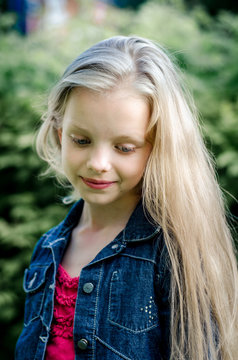 Portrait of a beautiful blonde little girl with long hair