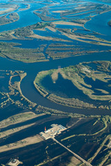 Oil rig in flooded area near great river, top view