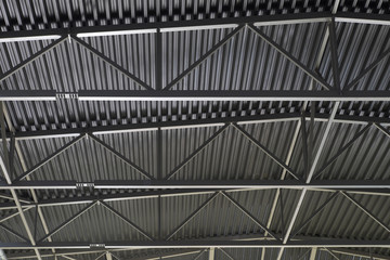 Metal roof inside the hangar. Large room with a tin roof.