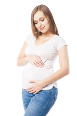 Portrait of beautiful pregnant woman embracing belly