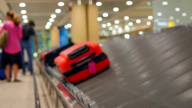 suitcase on conveyor belt at the airport coming toward the camera out of focus