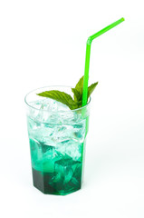 Iced green peppermint syrup with tonic water and ice cubes. Isolated on white background.