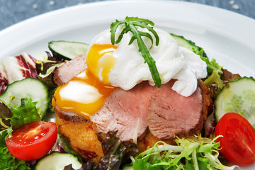 Restaurant food closeup, poached egg with meat