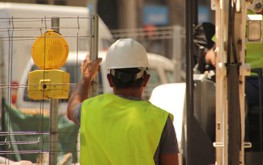Worker with jacket and helmet in a construction site