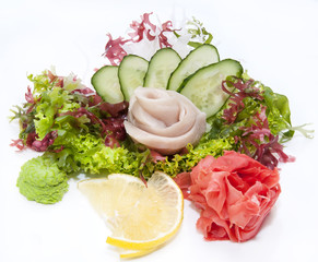 Japanese cuisine sashimi with vegetables and fish in a restaurant