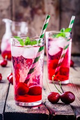cherry lemonade with ice and mint in glasses