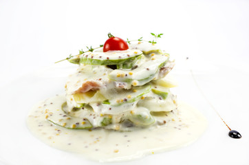 Herring salad with avocado sauce on a plate in a restaurant