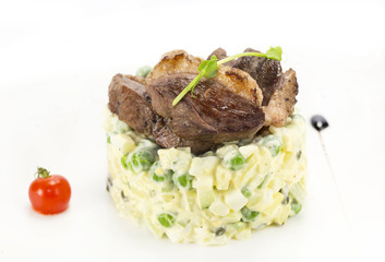 salad, fish and eggs decorated with greens and tomatoes