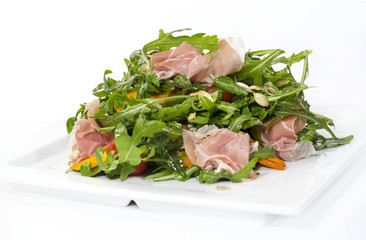 salad of arugula ham cheese on a white background