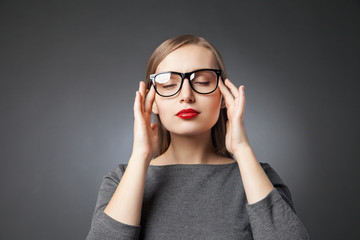 Woman in glasses with red lips meditating. eyes closed