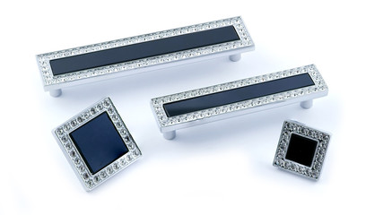 furniture handles in silver with crystals and black glass on a white background