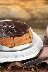 Tasty chocolate cake on wooden background